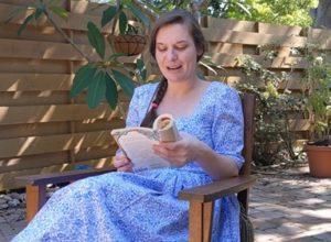 Palmetto Historical Park curator, Tori Chasey, reading "Strawberry Girl" by Lois Lenski