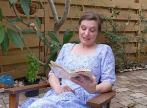 Palmetto Historical Park curator, Tori Chasey, reading "Strawberry Girl" by Lois Lenski