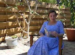 Palmetto Historical Park curator, Tori Chasey, reading "Strawberry Girl" by Lois Lenski