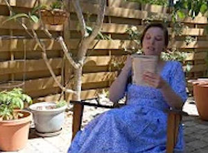 Palmetto Historical Park curator, Tori Chasey, reading "Strawberry Girl" by Lois Lenski