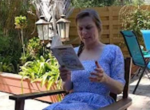 Palmetto Historical Park curator, Tori Chasey, reading "Strawberry Girl" by Lois Lenski