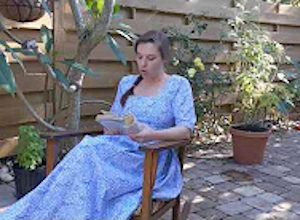 Palmetto Historical Park curator, Tori Chasey, reading "Strawberry Girl" by Lois Lenski