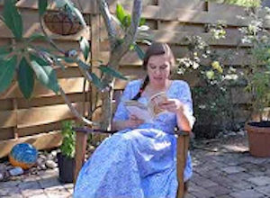 Palmetto Historical Park curator, Tori Chasey, reading "Strawberry Girl" by Lois Lenski