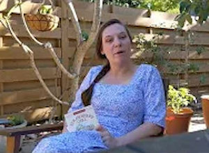 Palmetto Historical Park curator, Tori Chasey, reading "Strawberry Girl" by Lois Lenski