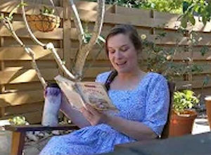 Palmetto Historical Park curator, Tori Chasey, reading "Strawberry Girl" by Lois Lenski